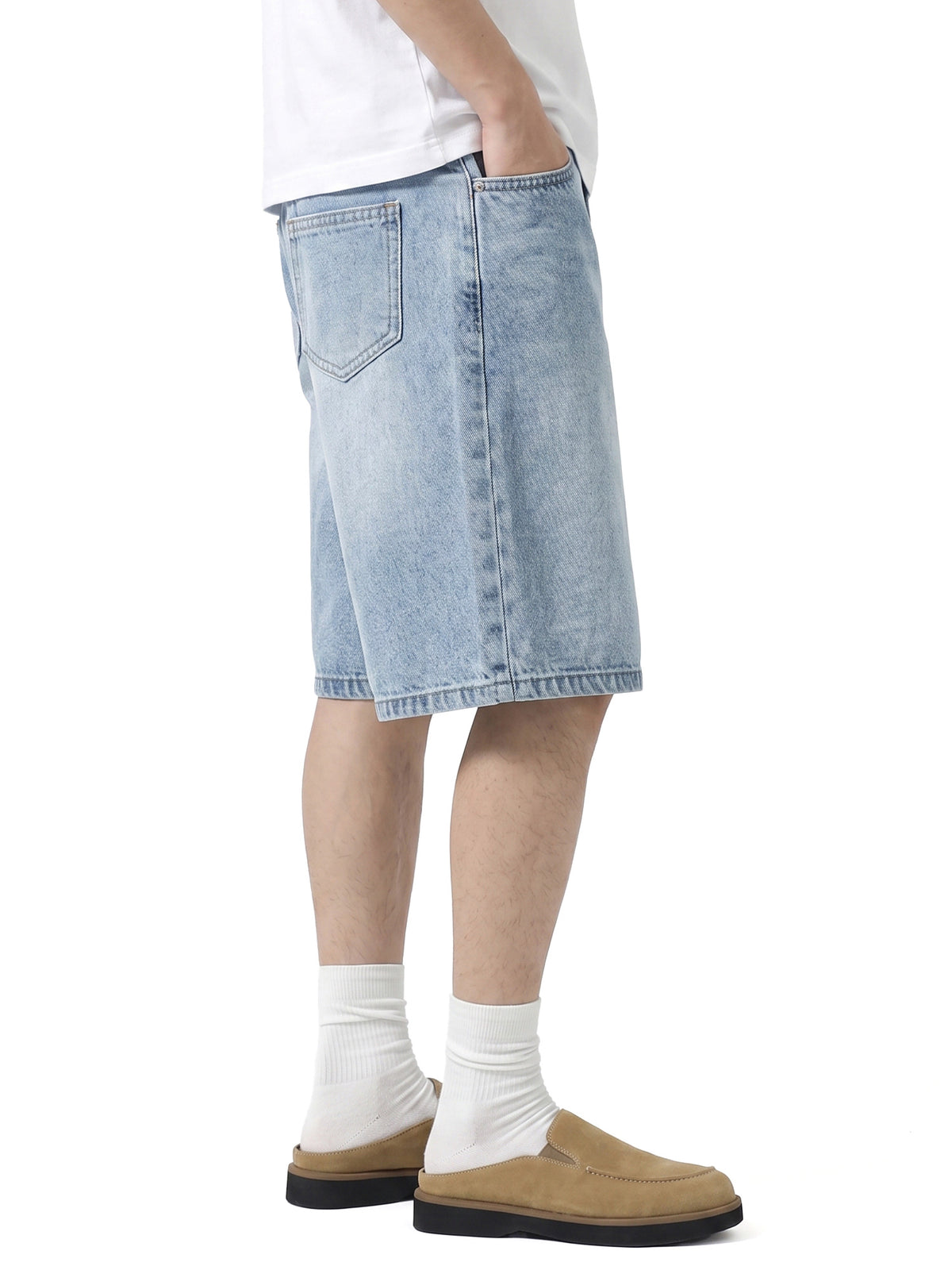 Model wearing 017 men's relaxed denim shorts in Light Blue, side view