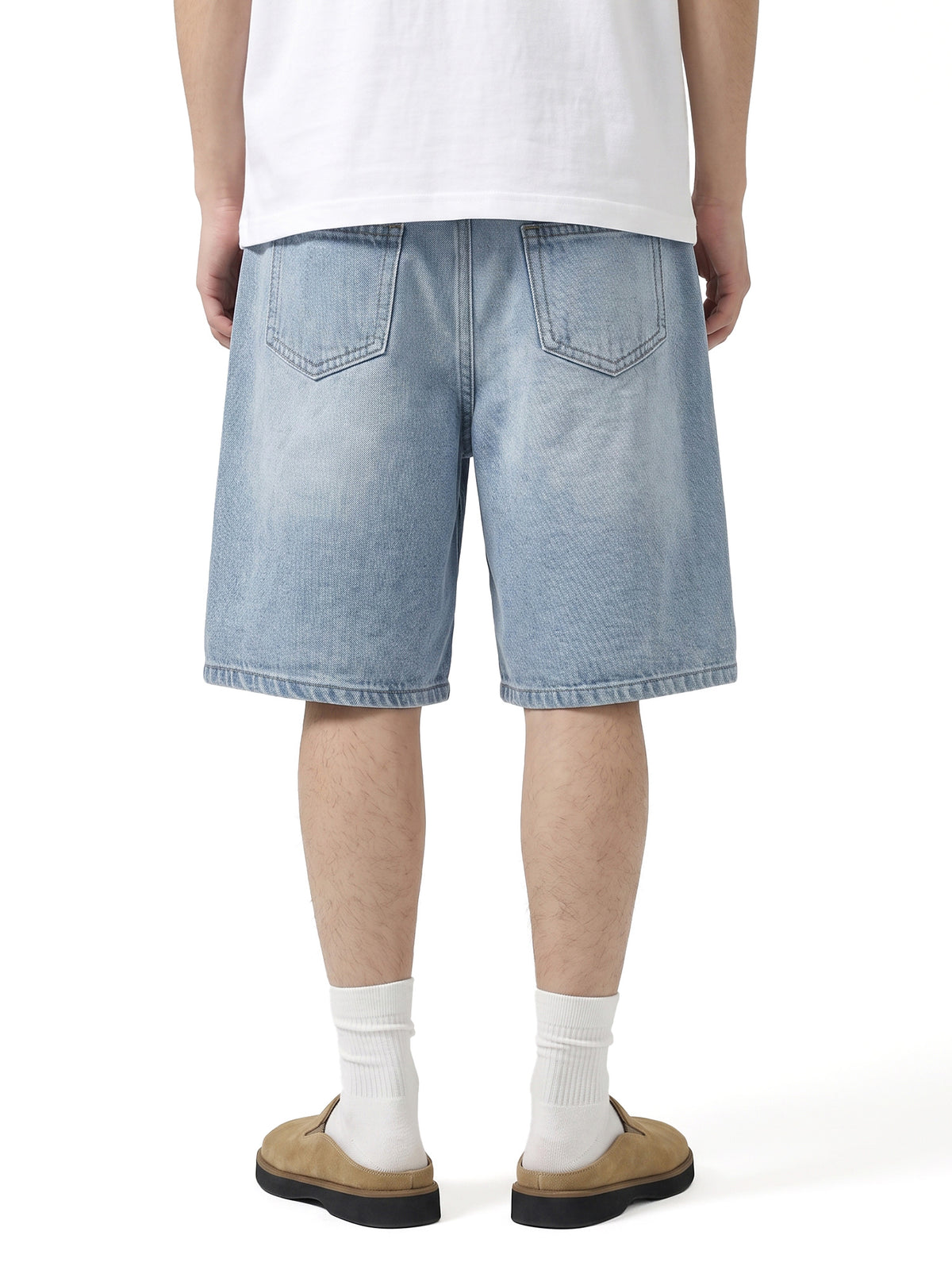 Model wearing 017 men's relaxed denim shorts in Light Blue, back view
