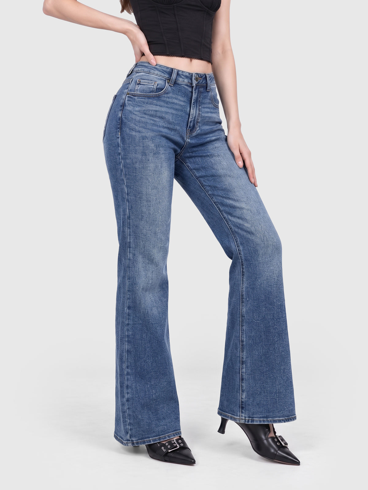 Model wearing B2228 women's flare denim jeans in Blue, side view