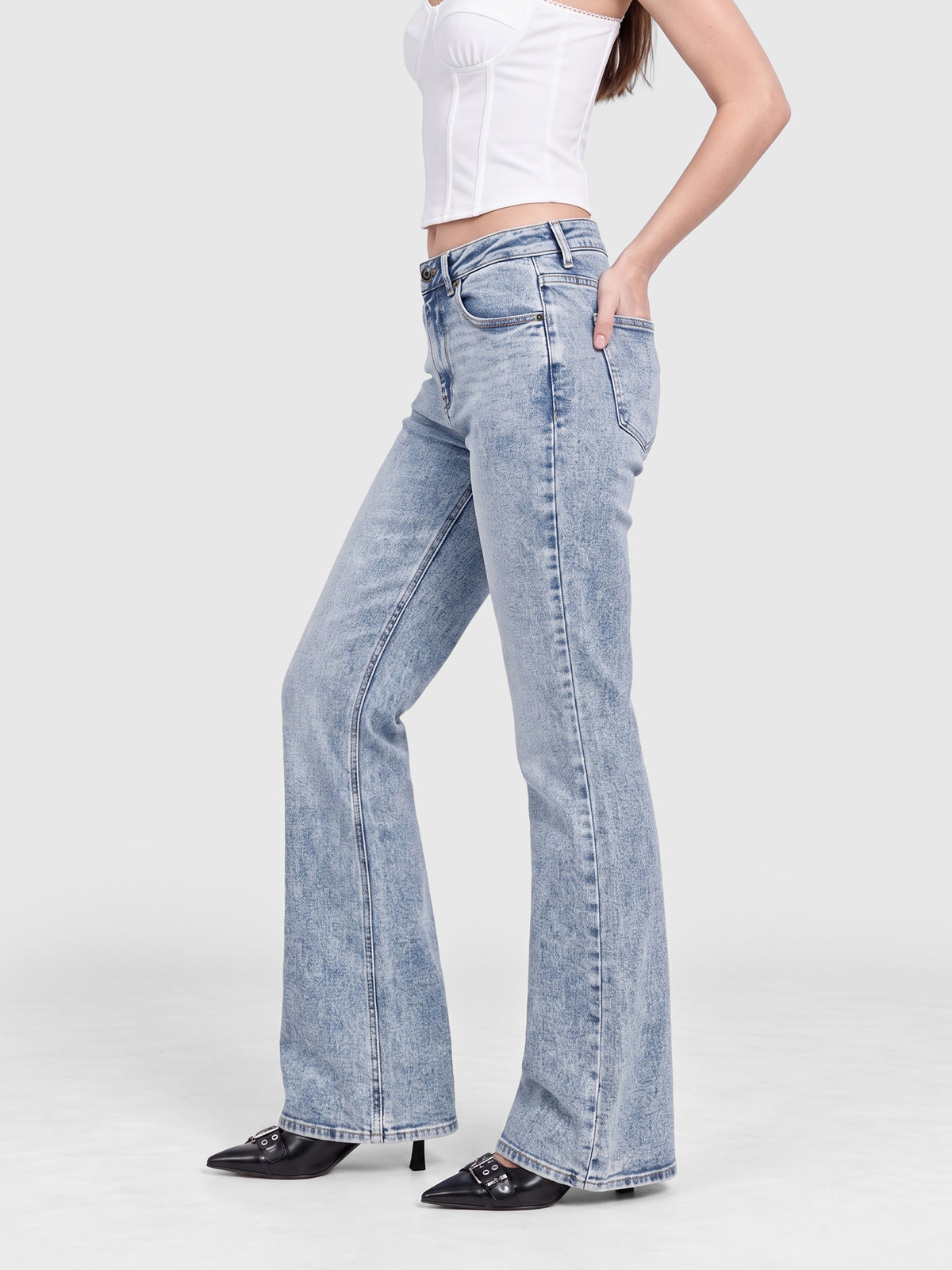 Model wearing B2228 women's flare denim jeans in Light Blue, side view
