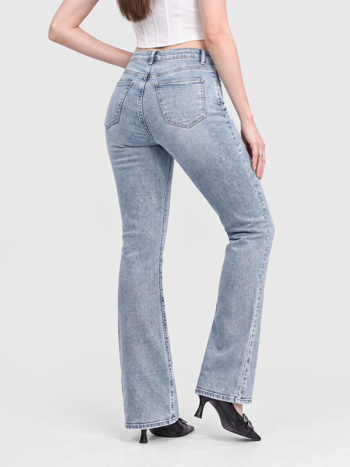 Model wearing B2228 women's flare denim jeans in Light Blue, back view
