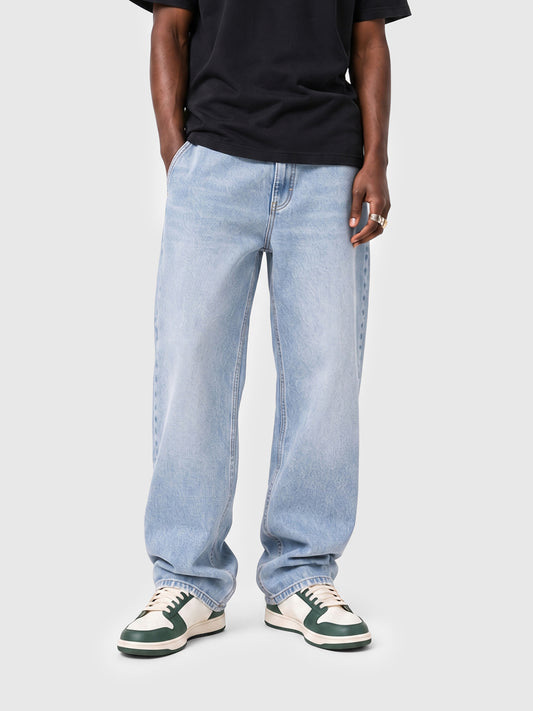 Model wearing B704 men's wide-leg denim jeans in Soft Light Blue, front view 1