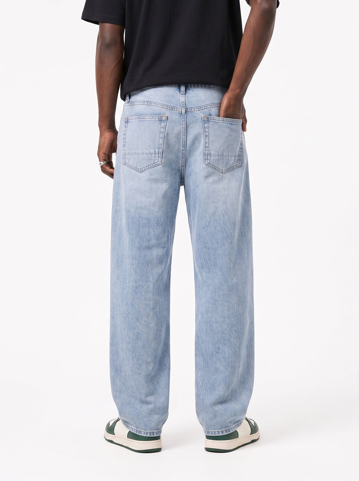 Model wearing B704 men's wide-leg denim jeans in Soft Light Blue, back view