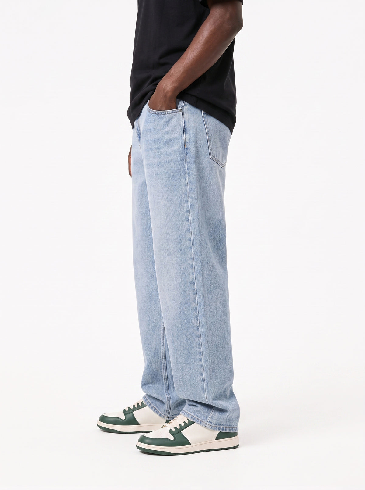 Model wearing B704 men's wide-leg denim jeans in Soft Light Blue, side view