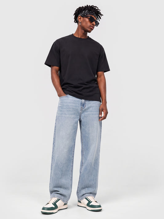 Model wearing B704 men's wide-leg denim jeans in Soft Light Blue, front view 2