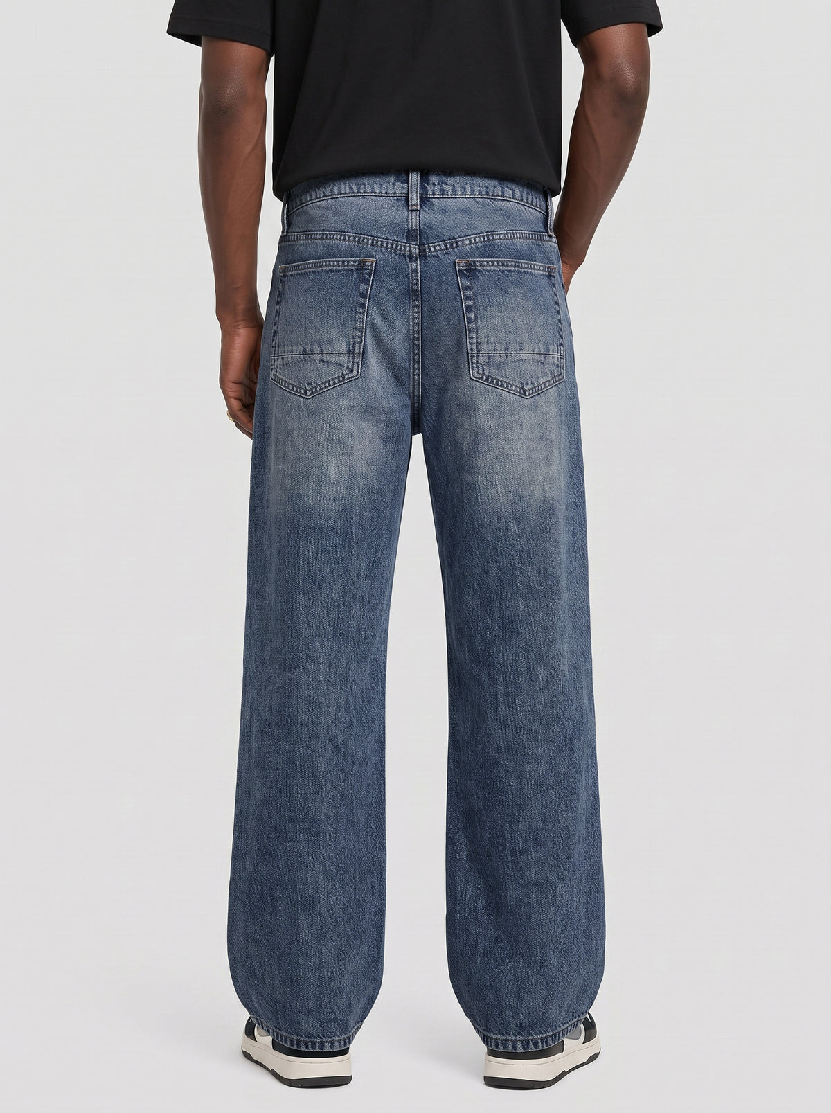 Model wearing B704 men's wide-leg denim jeans in Dark Blue, back view