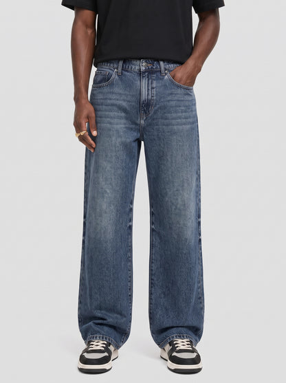 Model wearing B704 men's wide-leg denim jeans in Dark Blue, front view