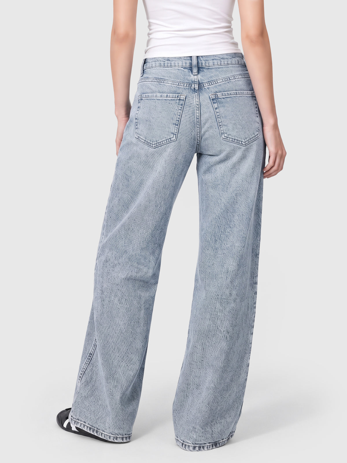 Model wearing BT242207 women's wide-leg denim jeans in Clean Blue, back view