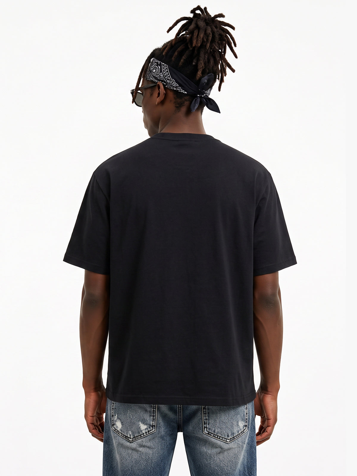 Model wearing US001 basic T-shirt in Black, back view