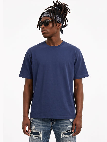 Model wearing US001 basic T-shirt in Navy, front view