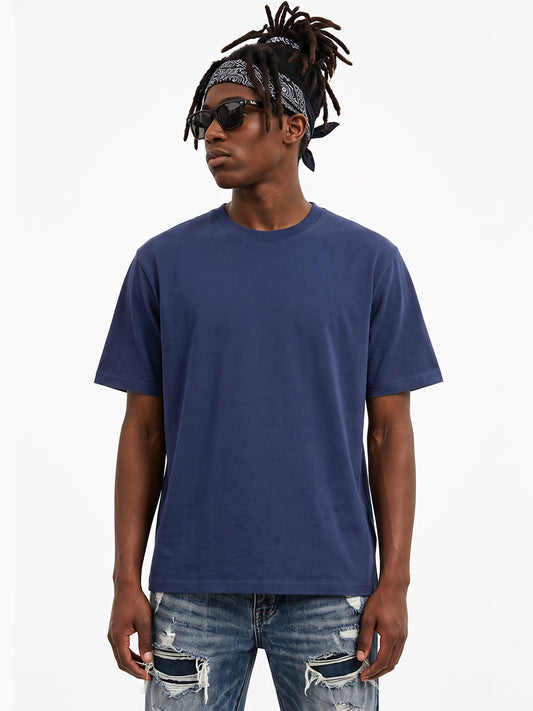 Model wearing US001 basic T-shirt in Navy, front view