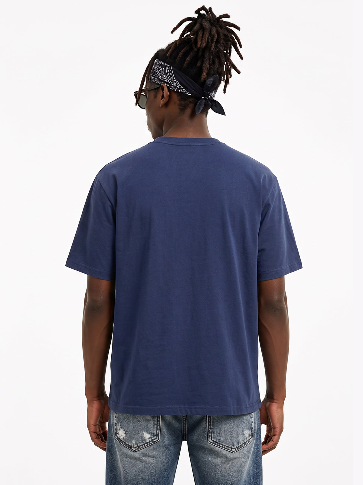 Model wearing US001 basic T-shirt in Navy, back view