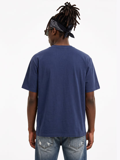 Model wearing US001 basic T-shirt in Navy, back view