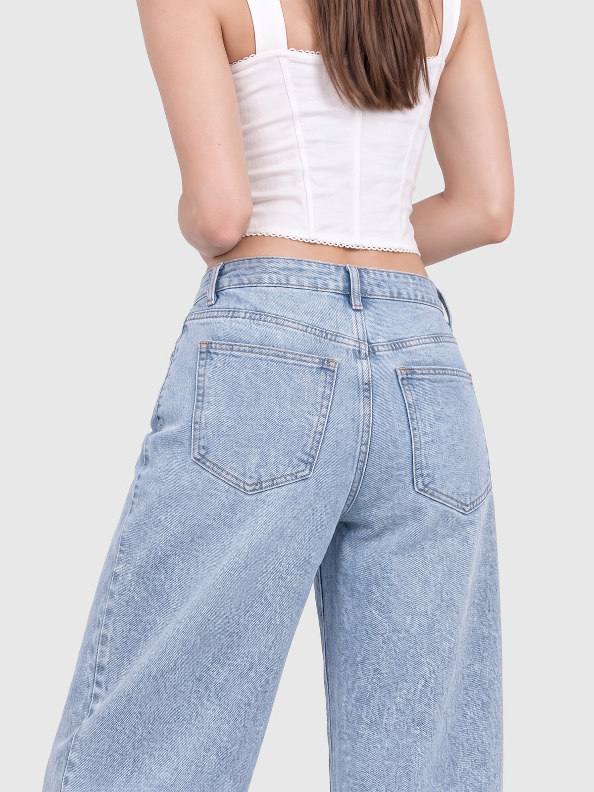 Model wearing JDP2512-15 women's wide-leg denim jeans in Light Blue, back view