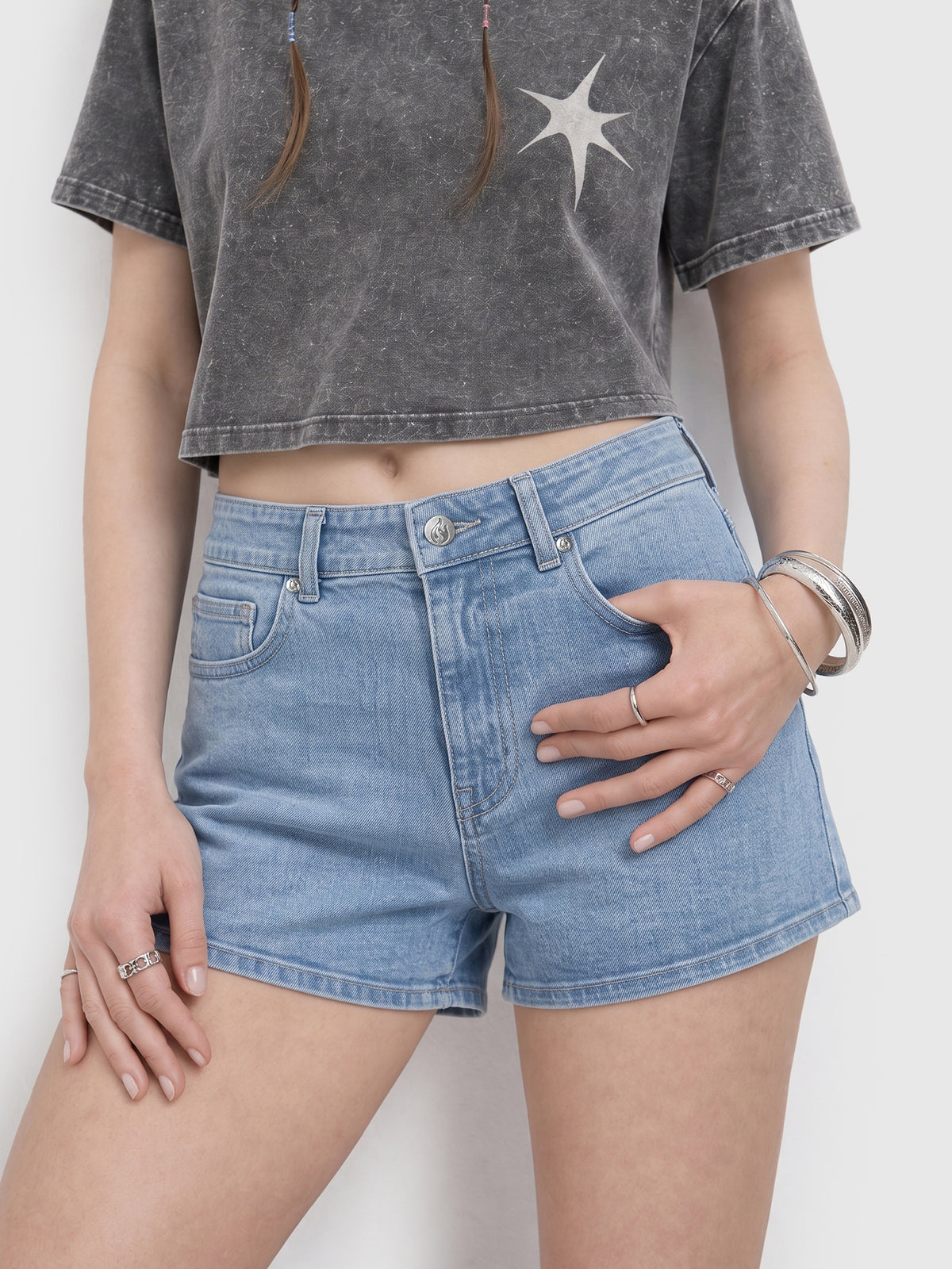 Model wearing RB20260303 women's high-rise denim shorts in Light Blue, front view 2