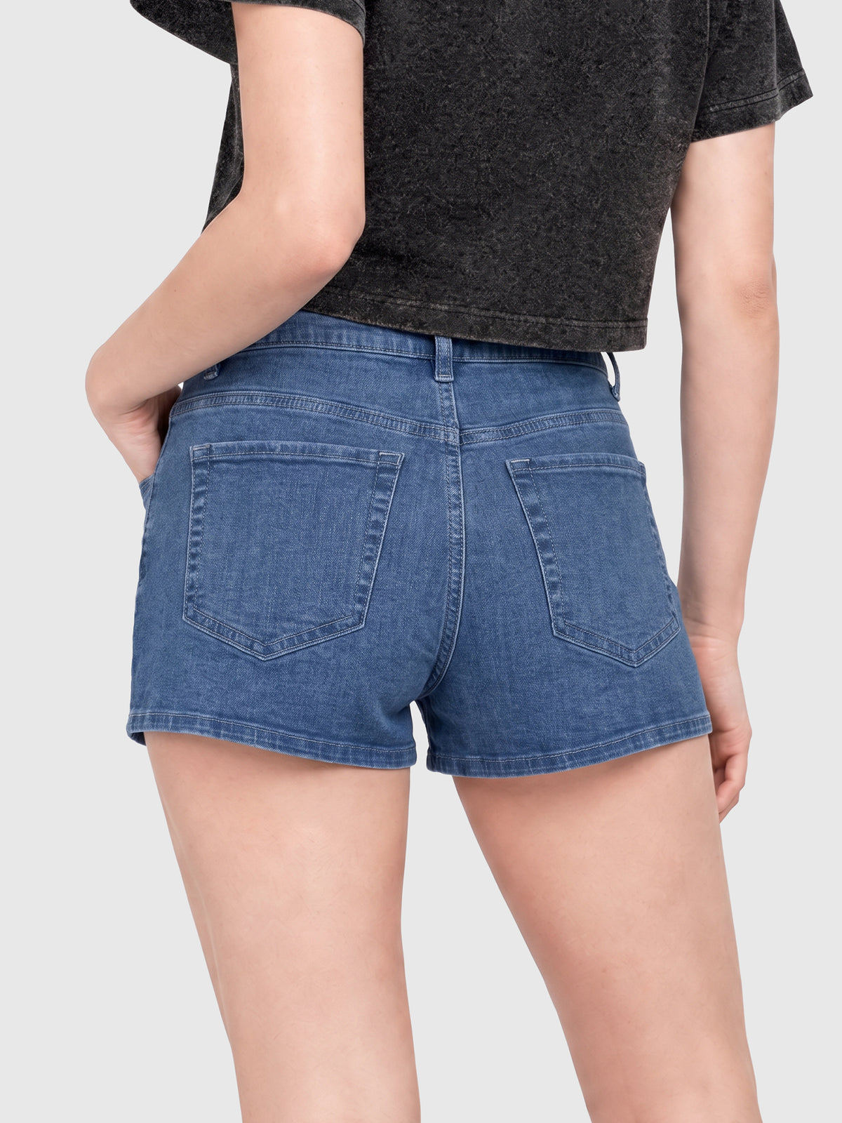 Model wearing RB20260303 women's high-rise denim shorts in Indigo, back view 1