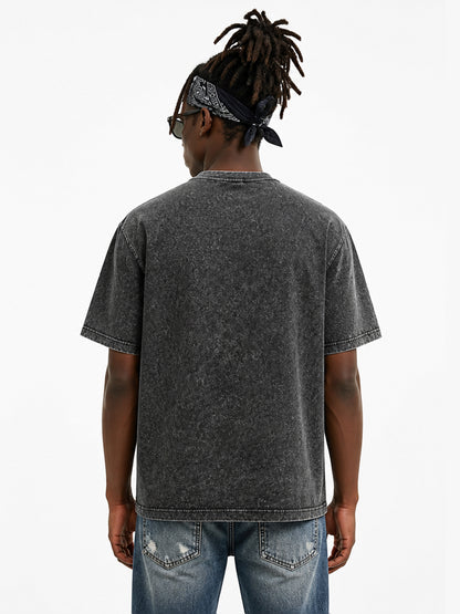 Model wearing US005 vintage washed T-shirt in Washed Black, back view